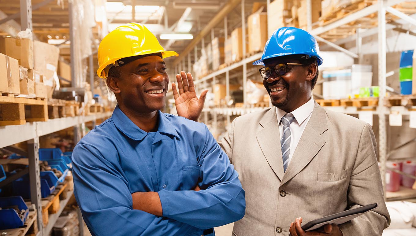 Men in hardhats smiling 