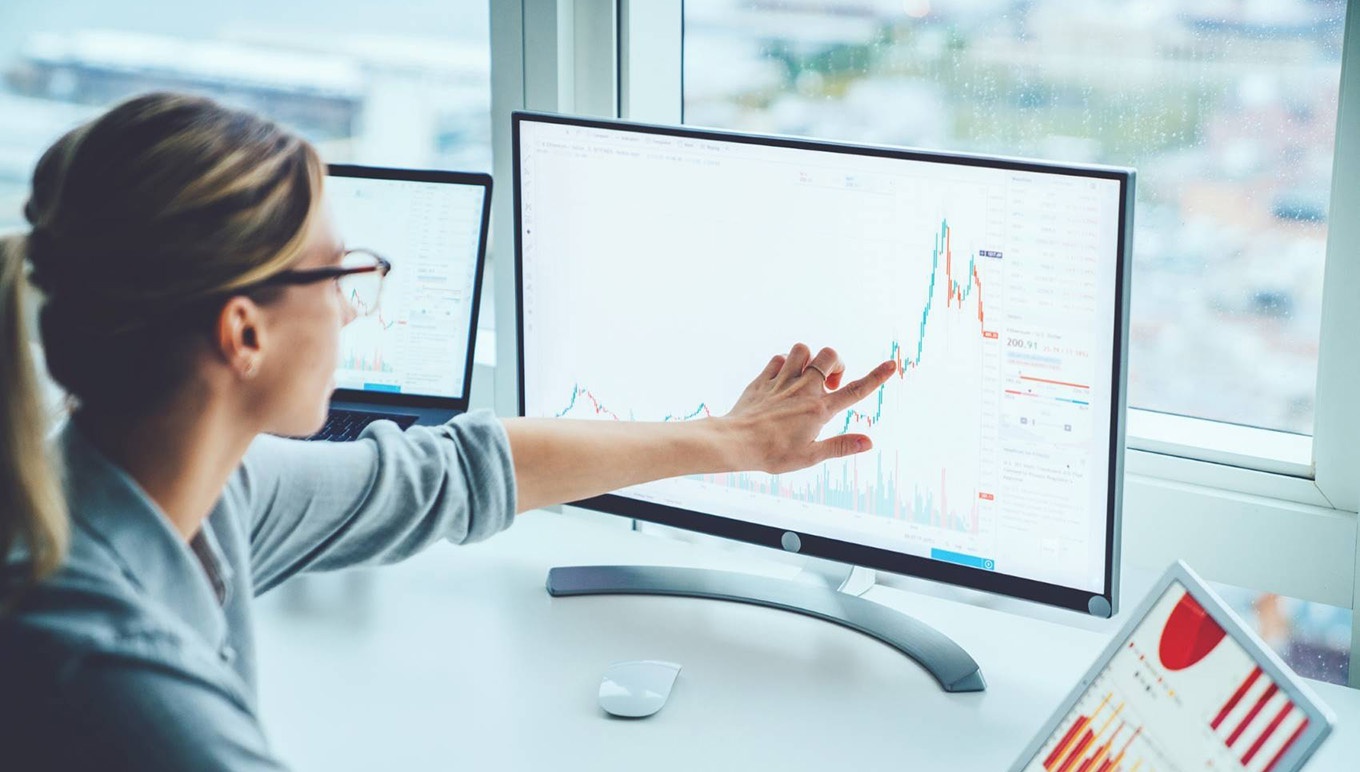 woman pointing at computer screen