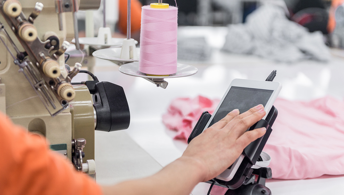 Person using a tablet in production line
