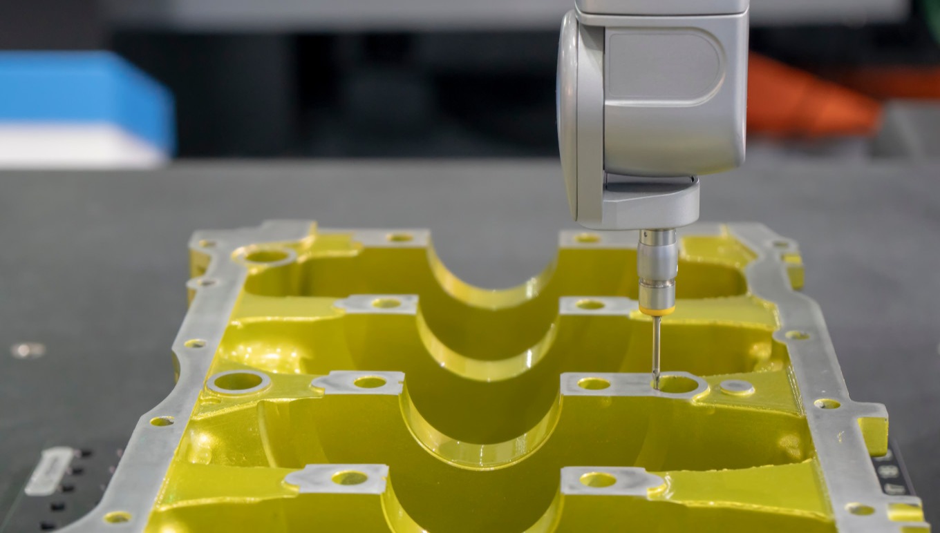 Machine measuring the aluminum automotive part for quality control calibration.