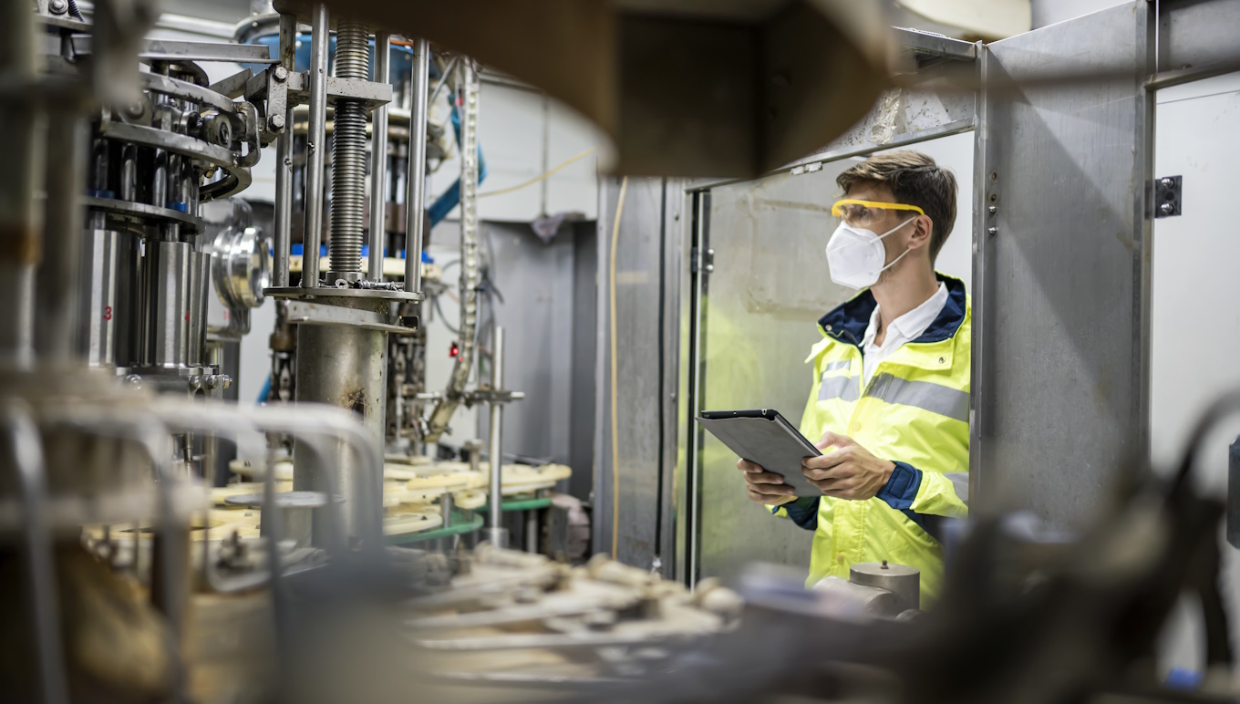 Engineer working at Fruit juice Bottle Automated conveyor belt.