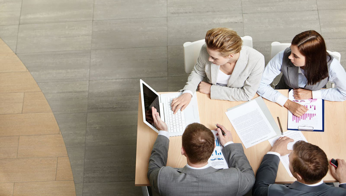 Four individuals having a business meeting.