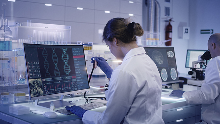 Scientist working on a desktop computer