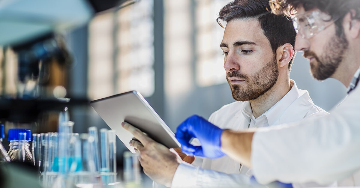 Scientists reviewing tablet