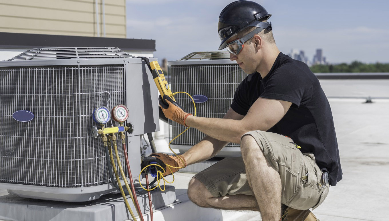 HVAC tech looking at a multimeter