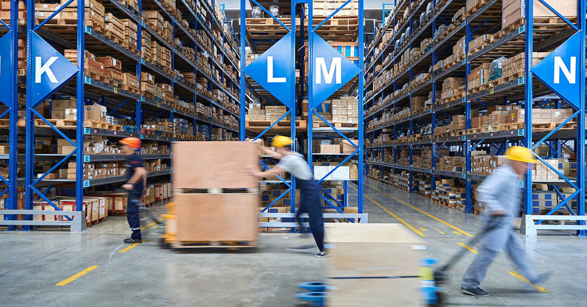 Warehouse workers moving crates and products.