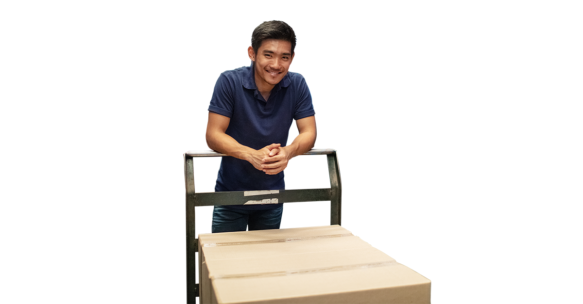 Man behind dolly cart in warehouse