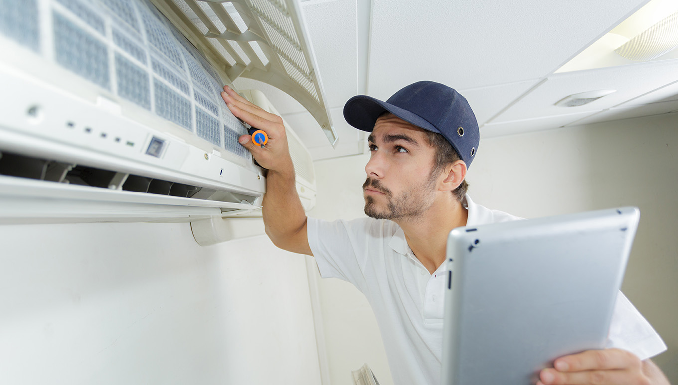 Repair man holding a tablet inspecting