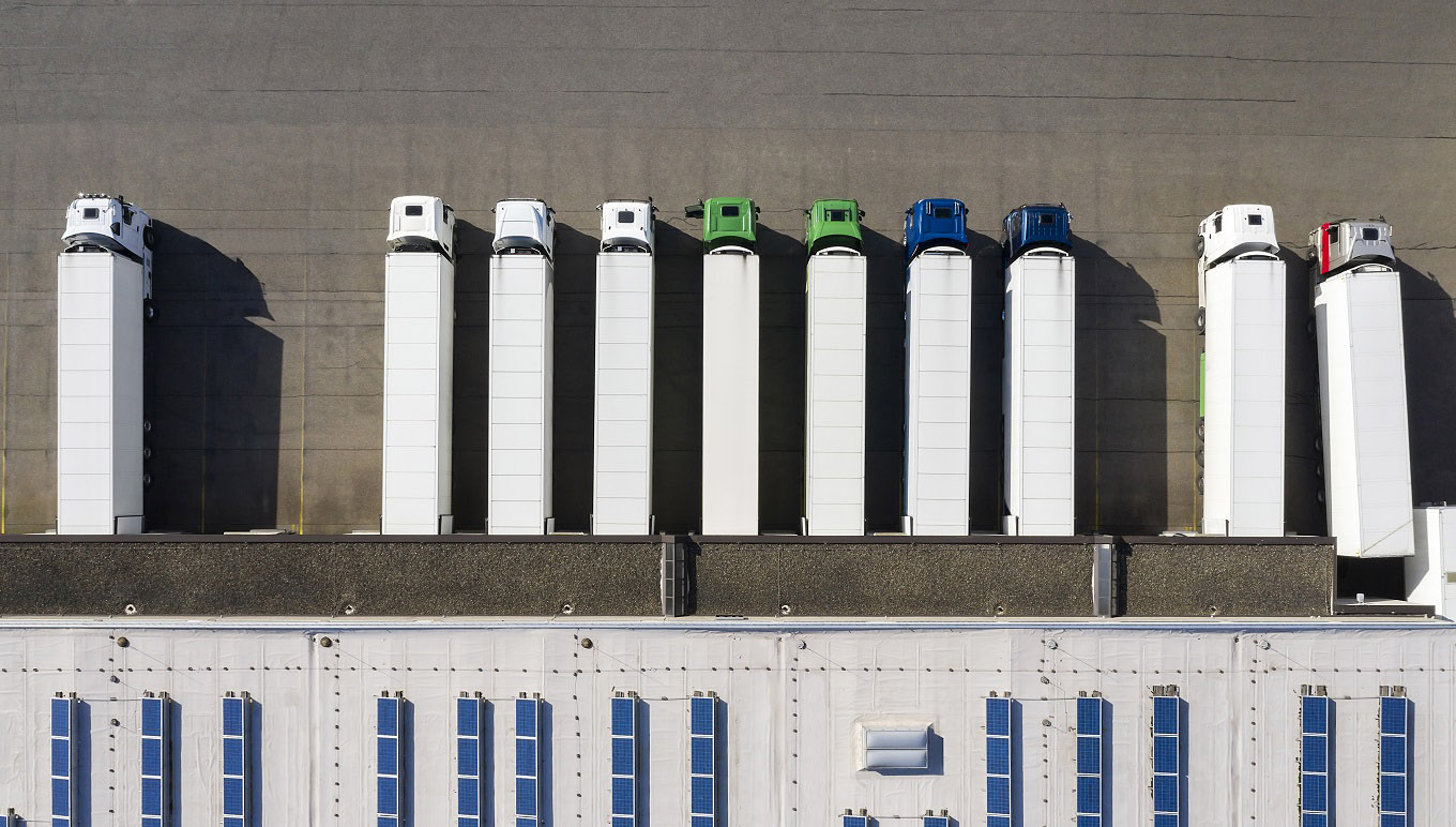 Trucks outside large warehouse