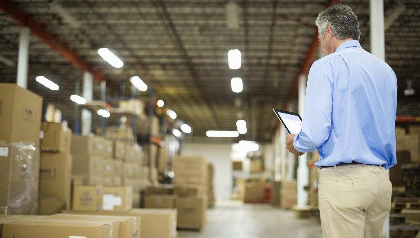 Man looking at inventory holding a clipboard.