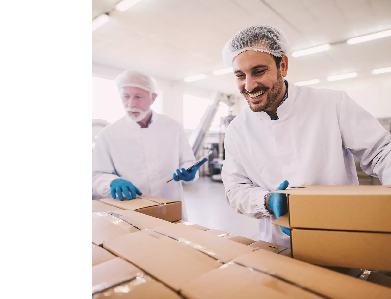 Two men organizing boxes for shipping.