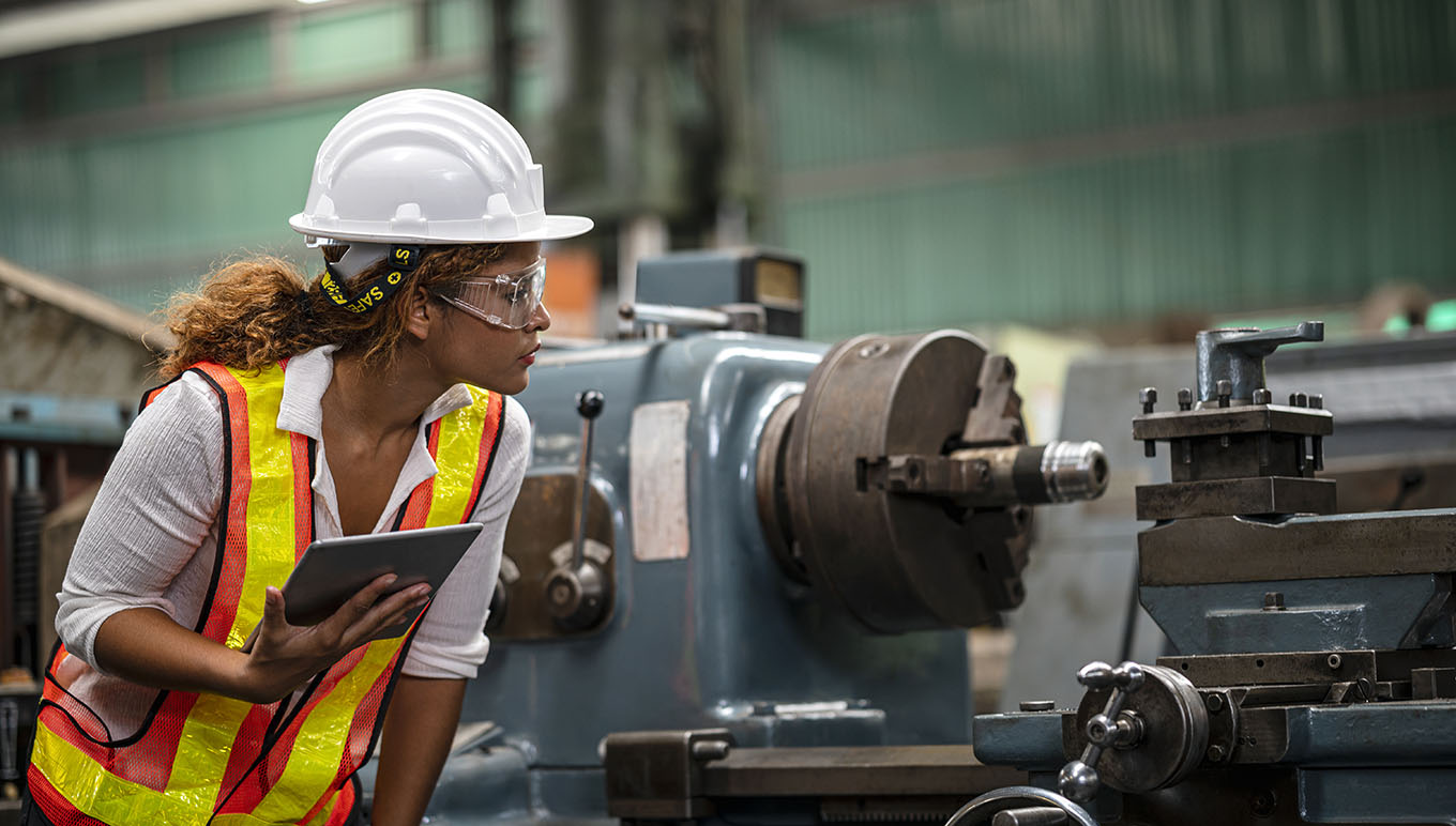 woman in a hardhat on shop floor